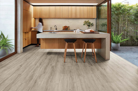 Highland Oak Hybrid Plank Regal Cove in a modern kitchen with a concrete island bench and timber cabinetry