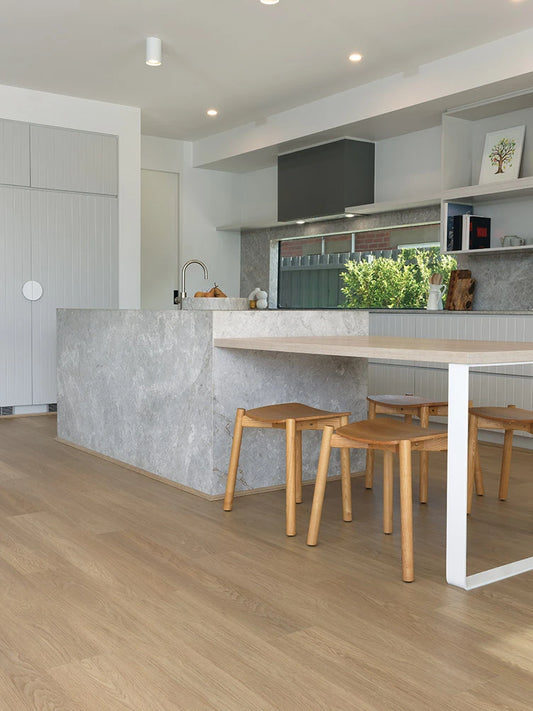 Summerhill Hybrid Plank Brown Maple in a modern kitchen with a stone island bench and warm timber cabinetry
