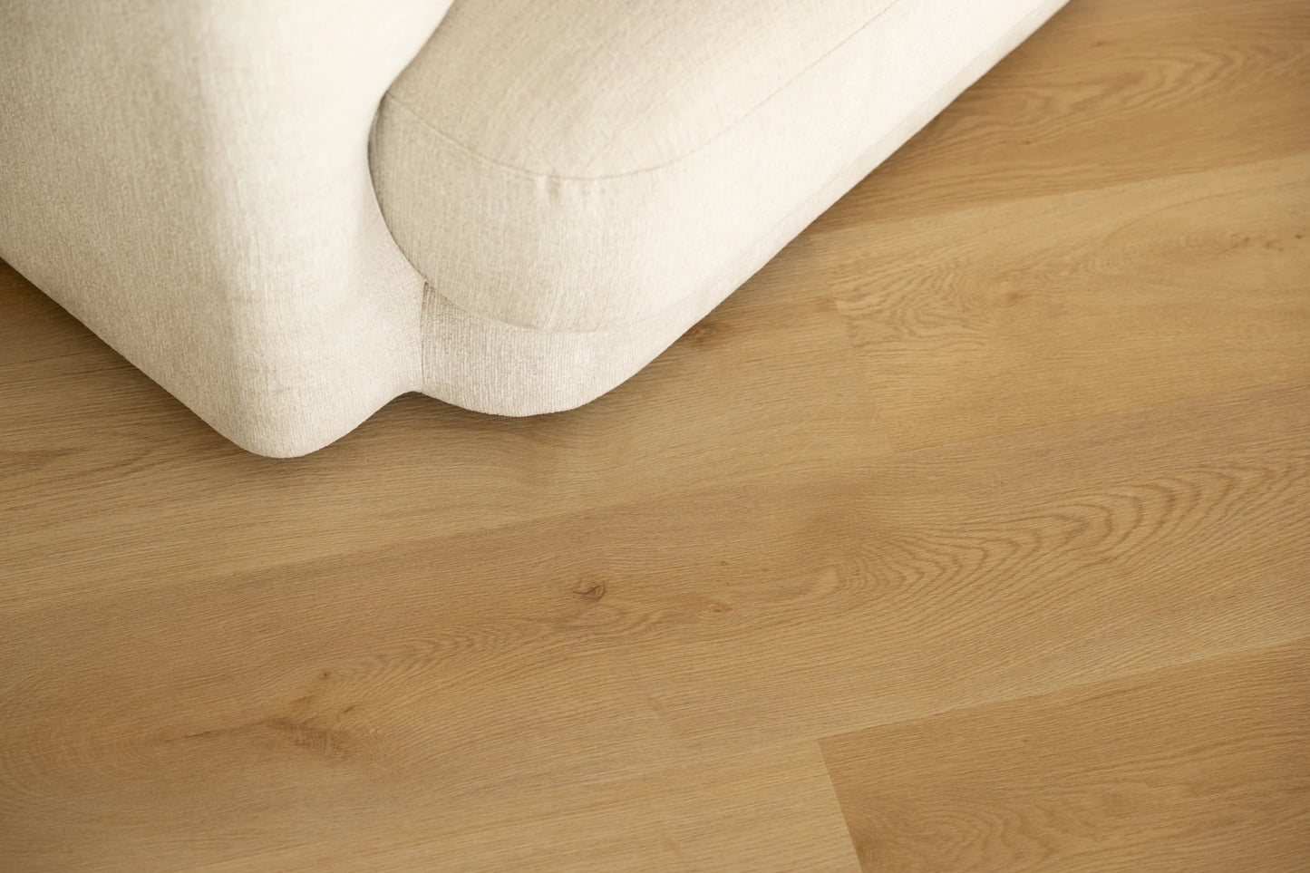 Coastal Collection Bokarina Oak luxury vinyl plank flooring with a cream boucle sofa in a Sunshine Coast living room