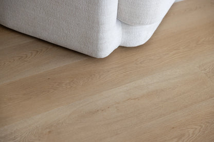 Coastal Collection Bokarina Oak luxury vinyl plank flooring with a cream boucle sofa in a Sunshine Coast living room