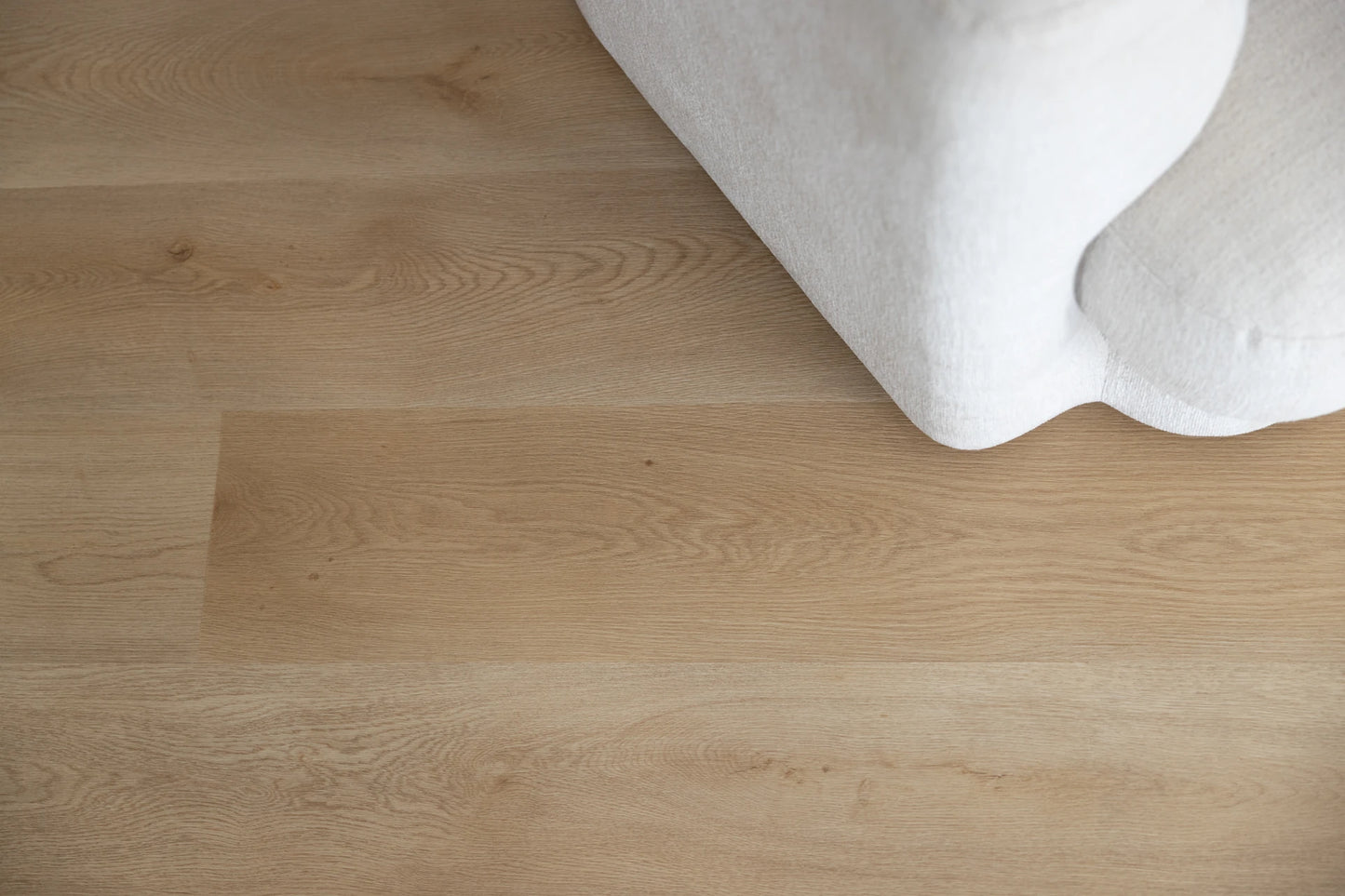 Coastal Collection Bokarina Oak luxury vinyl plank flooring with a cream boucle sofa in a Sunshine Coast living room