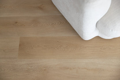 Coastal Collection Bokarina Oak luxury vinyl plank flooring with a cream boucle sofa in a Sunshine Coast living room