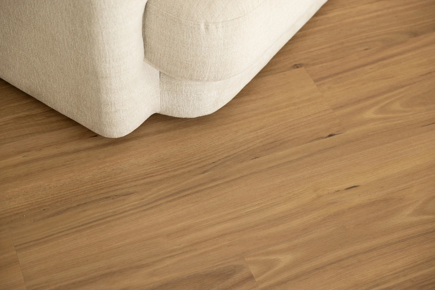 Coastal Collection Buderim Blackbutt luxury vinyl plank flooring with a cream boucle sofa in a Sunshine Coast living room