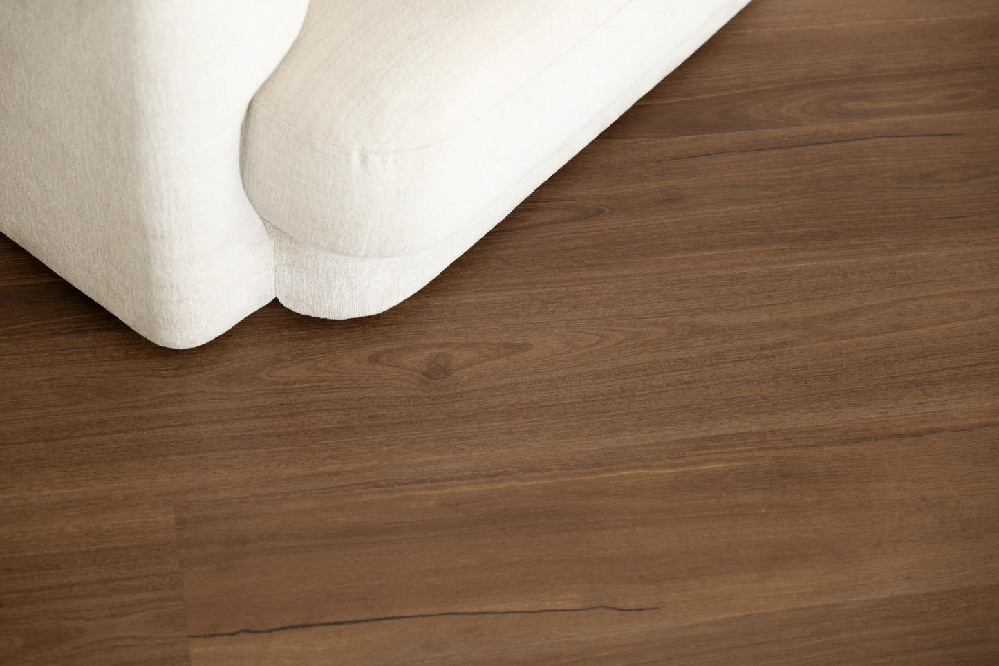 Coastal Collection Maleny Spotted Gum luxury vinyl plank flooring with a cream boucle sofa in a Sunshine Coast living room