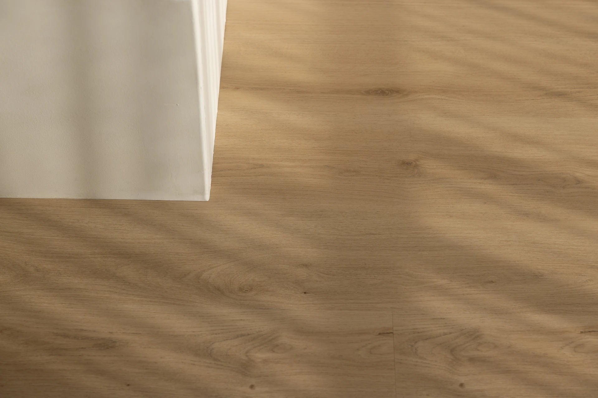 Coastal Collection Minyama Oak luxury vinyl plank flooring with a cream boucle sofa in a Sunshine Coast living room