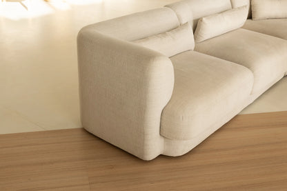 Coastal Collection Noosa Oak luxury vinyl plank flooring with a cream boucle sofa in a Sunshine Coast living room