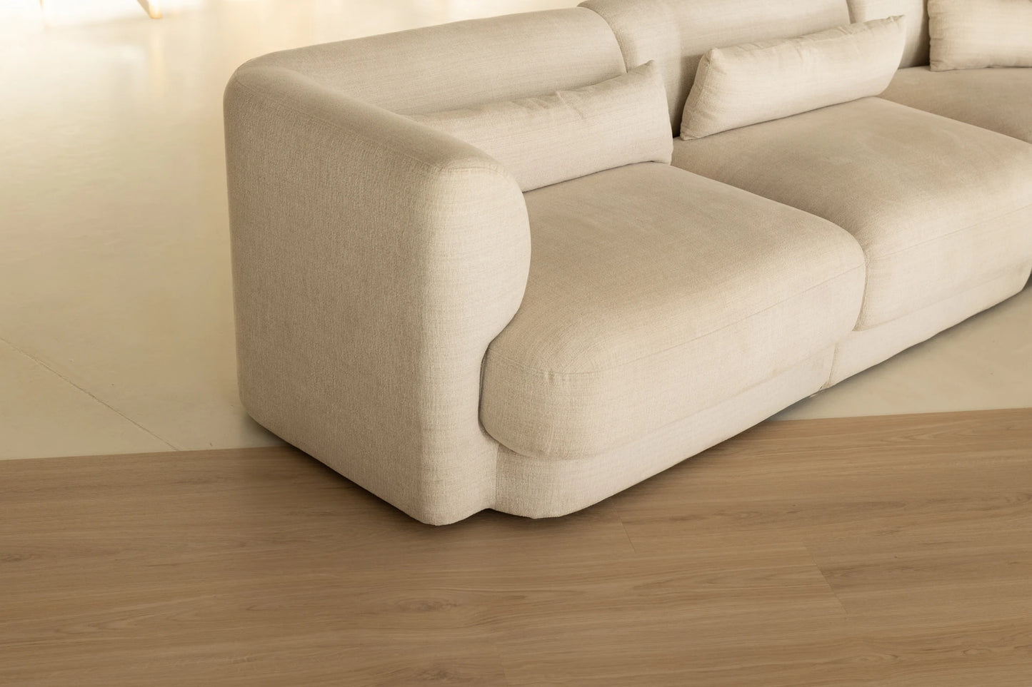 Coastal Collection Sunshine Beach Oak luxury vinyl plank flooring with a cream boucle sofa in a Sunshine Coast living room