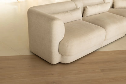 Coastal Collection Sunshine Beach Oak luxury vinyl plank flooring with a cream boucle sofa in a Sunshine Coast living room