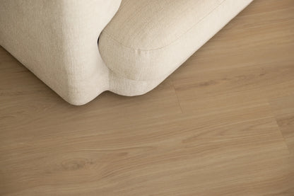 Coastal Collection Sunshine Beach Oak luxury vinyl plank flooring with a cream boucle sofa in a Sunshine Coast living room