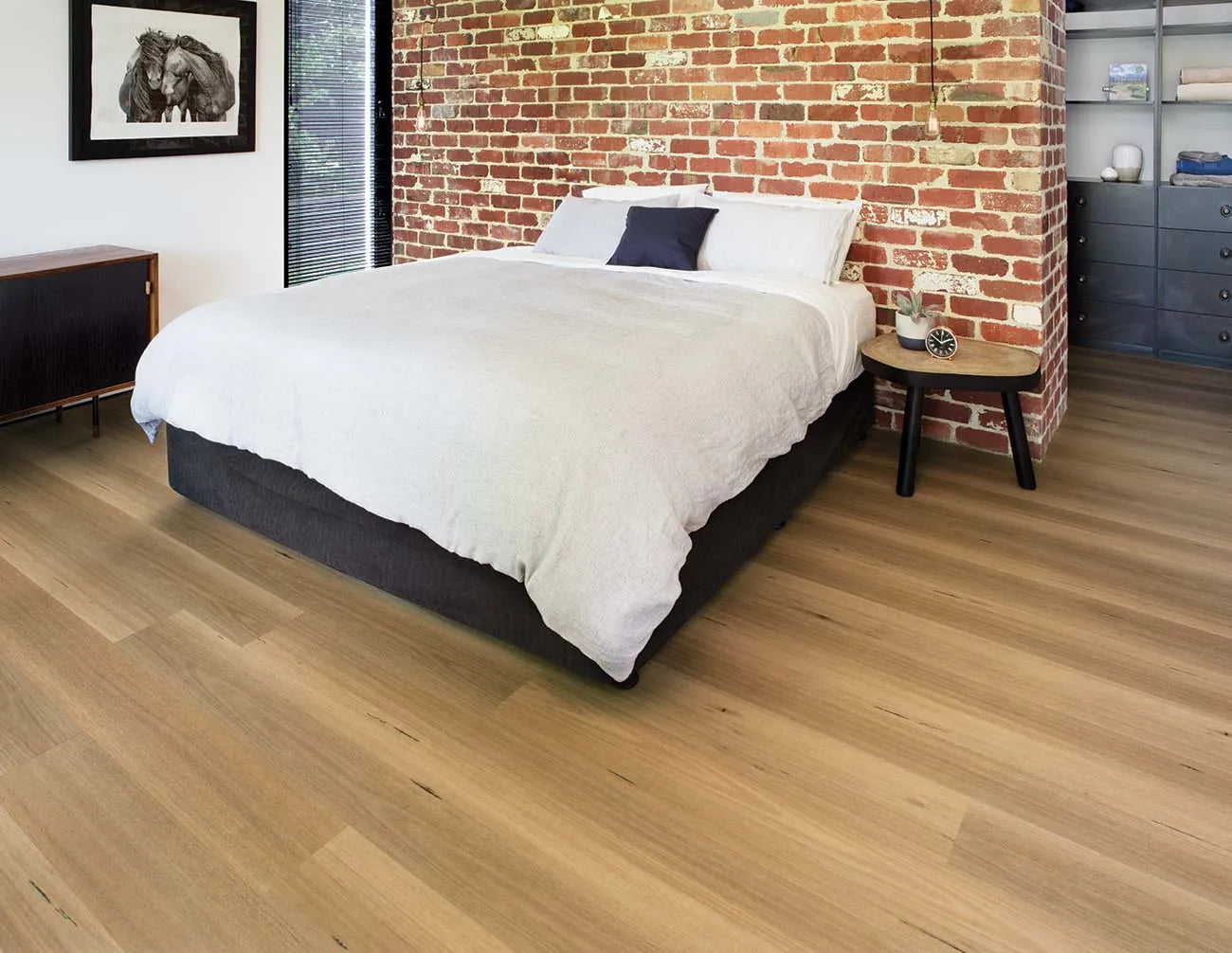 Australian Hybrid Plank Blackbutt in a modern bedroom with an exposed brick feature wall and timber bedhead