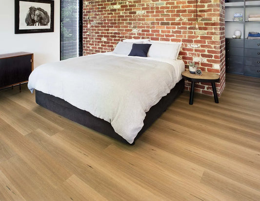 Australian Hybrid Plank Blackbutt in a modern bedroom with an exposed brick feature wall and timber bedhead