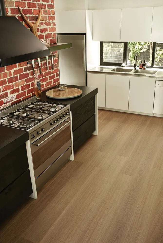 Australian Hybrid Plank Tasmanian Oak in a modern kitchen with an exposed brick splashback and timber benchtop