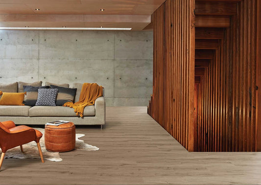 Highland Oak Hybrid Plank Dalmore Ash in an architectural open-plan living room with concrete walls and timber slat detailing
