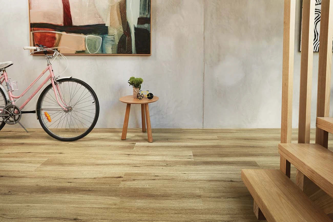 Natural Oak Vinyl Plank Nevada Plain in a modern entryway featuring a pink bicycle and small timber table