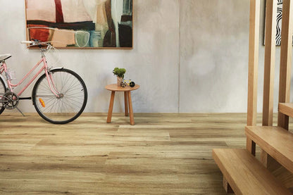 Natural Oak Vinyl Plank Nevada Plain in a modern entryway featuring a pink bicycle and small timber table