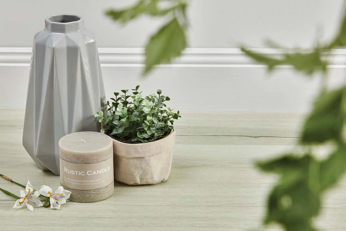 Natural Oak Vinyl Plank Oslo White close-up with a geometric grey vase, eucalyptus and a rustic candle