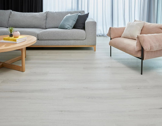 Natural Oak Vinyl Plank Oslo White in a contemporary living room with grey sofa and blush armchair