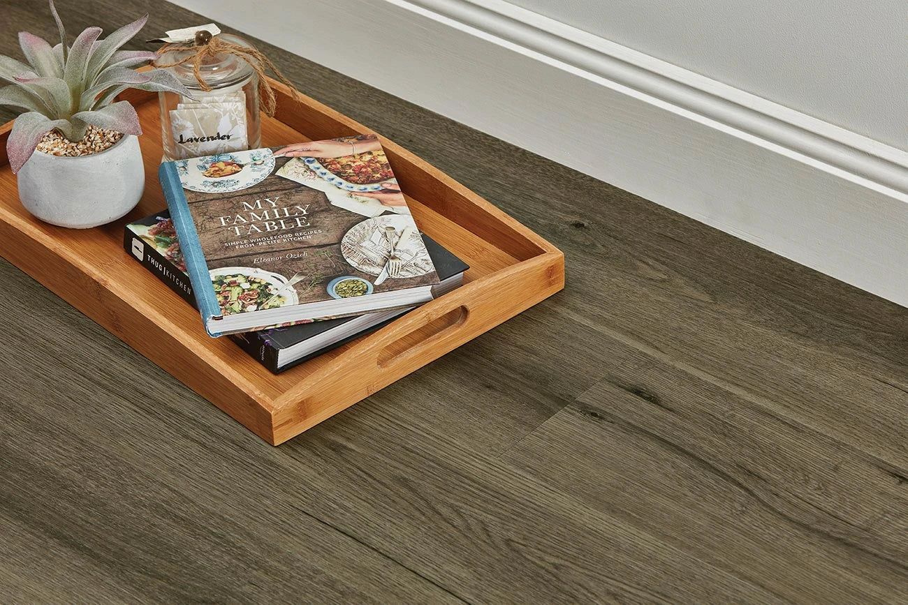 Natural Oak Vinyl Plank Provincial Grey close-up with a bamboo serving tray, recipe books and a succulent