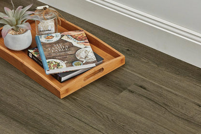 Natural Oak Vinyl Plank Provincial Grey close-up with a bamboo serving tray, recipe books and a succulent