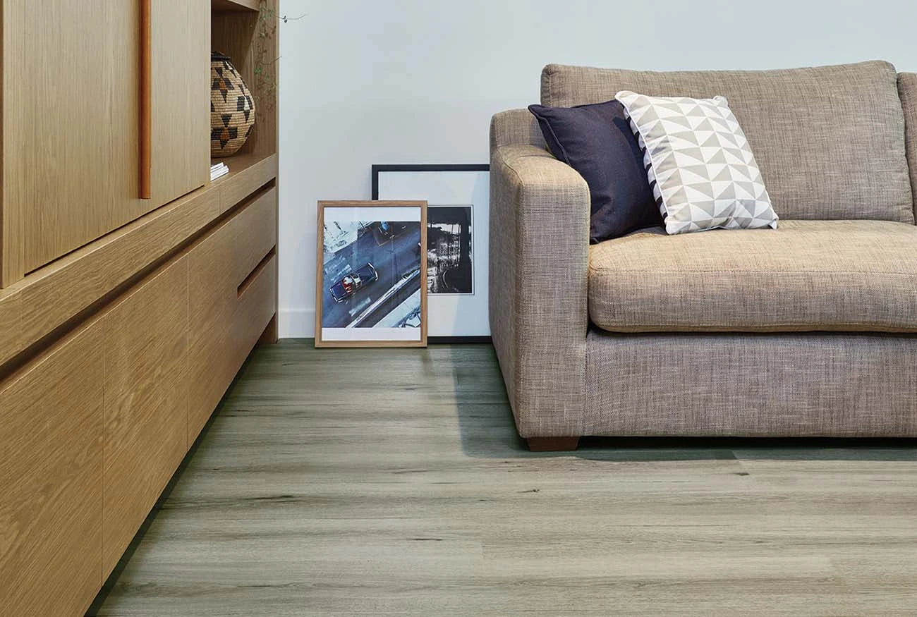 Natural Oak Vinyl Plank Tempest in a contemporary living room with a timber console and beige sofa
