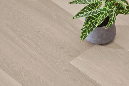 Smoked Oak Vinyl Plank Nordic Beech close-up styled with a concrete planter and a leafy indoor plant