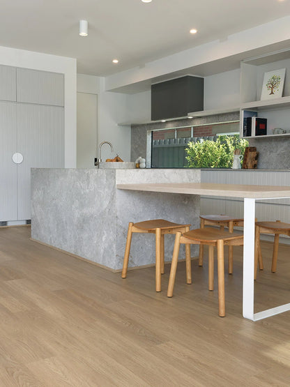 Summerhill Hybrid Plank Brown Maple in a modern kitchen with a stone island bench and warm timber cabinetry