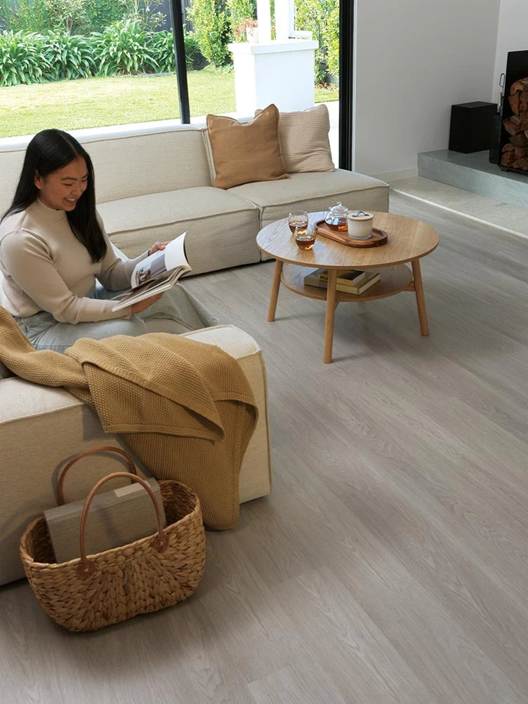 Summerhill Hybrid Plank Smokey Quartz in a contemporary living room with a cream modular sofa and garden view